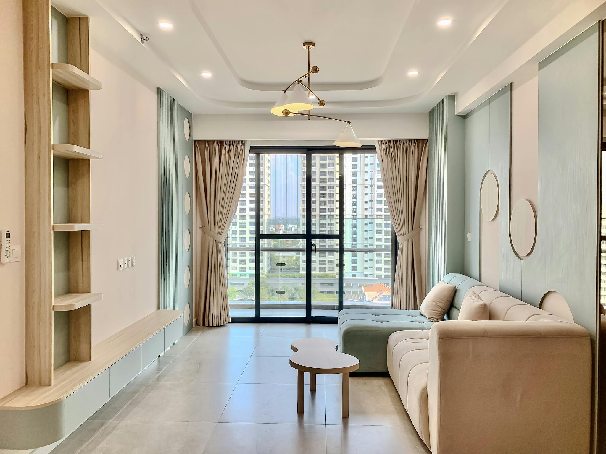 Bright and modern rental home living room with minimalist design and urban cityscape view.