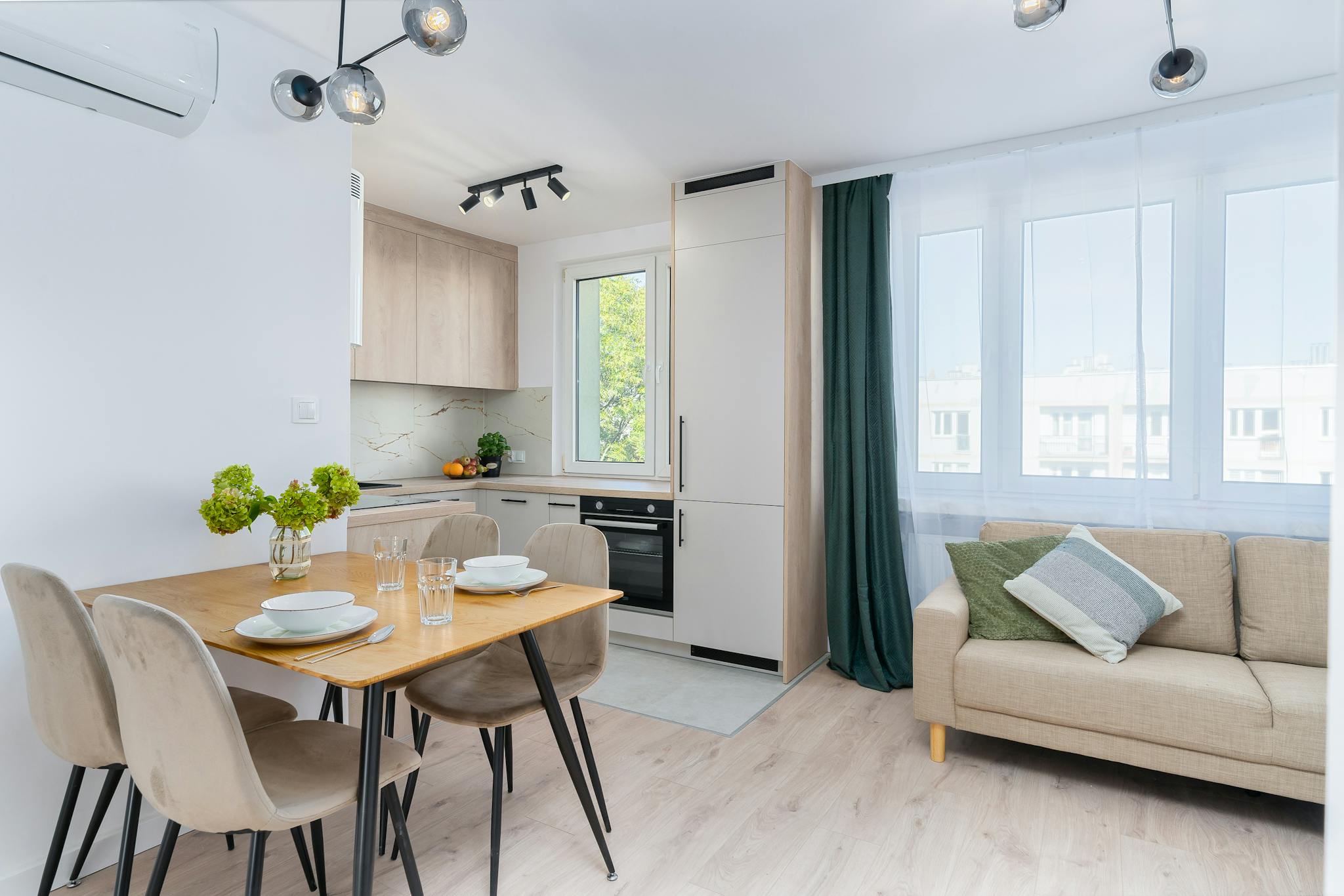 Bright rental home kitchen with dining area in Scandinavian style, featuring minimalist design.